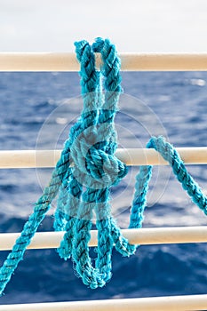 Blue Rope on White Ship Railing