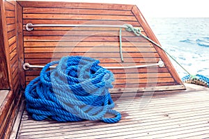 Blue rope on a yacht on a wooden table. Sea concept