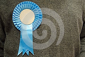 Blue Rosette on Conservative Party Supporter