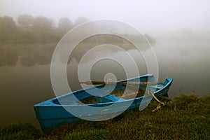 Blue rowboat in the fog