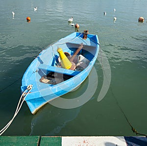 Blue rowboat in the mediterranean Sea