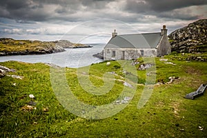 Blue rowing boat and white cottage near to Flodbay on the Isle of Harris