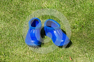 Blue rubber galoshes on the grass