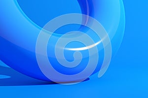 Blue rubber inflatable ring float on blue background