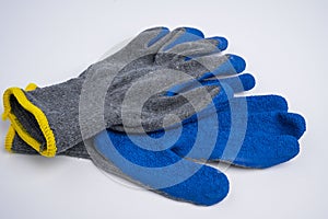 blue rubberized work gloves lie on a white background. construction and repair