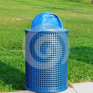 Blue rubbish bin in park