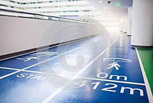 Blue running track in grand office building for employees to exercise and relax