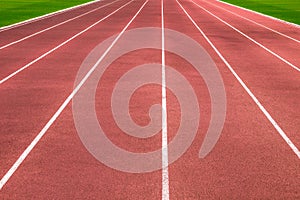 Blue running treadmill track with lane numbers in stadium outdoors.Starting grid of race track at the stadium