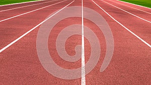 Blue running treadmill track with lane numbers in stadium outdoors.Starting grid of race track at the stadium