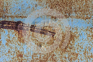 Blue rusted metal background. A rusty and scratched painted metal wall. Rusty metal background with streaks of rust