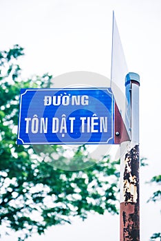 A blue rusted street sign with text