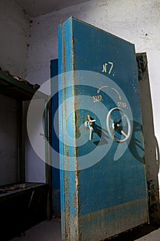 Blue rusty hermetical door of old abandoned Soviet bomb shelter photo