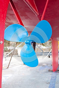 Blue sailboat propeller in a red hull