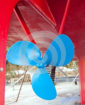 Blue sailboat propeller in a red hull