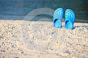 Blue sandals on the beach