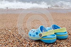 Blue sandals slipper on the sand