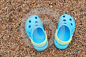 Blue sandals slippers on the sand