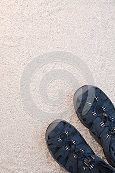 Blue sandals on white sand