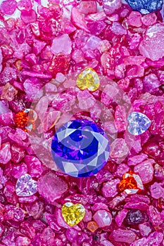 Blue Sapphire diamonds are placed in an enclave of colorful heart shaped diamonds
