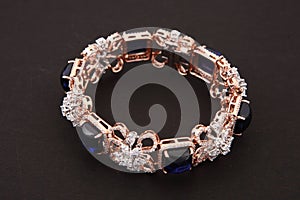 blue sapphire and white diamonds wedding bracelet crafted in gold. top view.