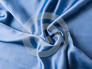 Blue satin texture background with waves and crease