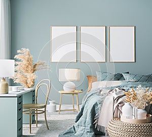 Blue Scandinavian bedroom with three vertical frames in bright design
