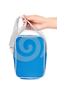 Blue school bag in hand isolated on white background.