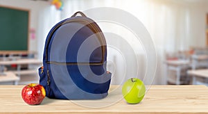 blue school bag next to an apple