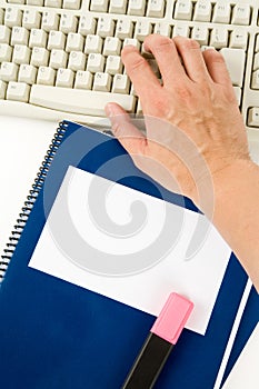 Blue school textbook and computer keyboard