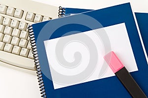 Blue school textbook and computer keyboard