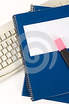 Blue school textbook and computer keyboard