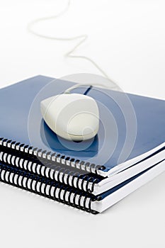 Blue school textbook and computer mouse