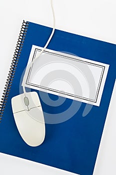 Blue school textbook and computer mouse