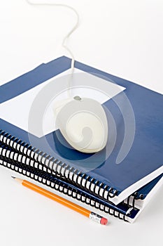 Blue school textbook and computer mouse