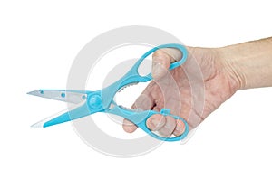 Blue scissors in hand close up on white background