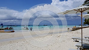 The blue sea and beach-spread parasols