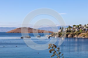 Blue sea, boats, mountains and small town on the coast of the Aegean sea. Summer holidays concept