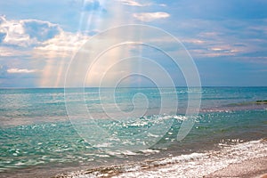 Blue sea and dark sky with sun rays on a summer day. Seascape