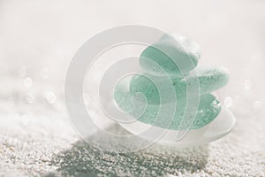 Blue sea glass with white sand beach