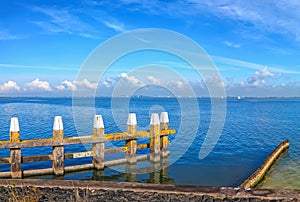 Blue sea harbor pier panoramic landscape. Magnificent blue sky over calm expanse on a sunny day. Pastoral Dutch seascape