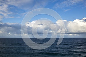 Blue sea or ocean water surface with horizon and sky