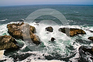 Blue sea and ocean waves  on the shoreline near the rocky coast of California