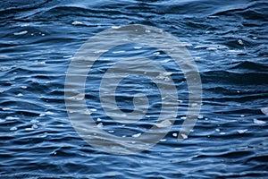 Blue sea, ocean waves, water with foam and bubbles, texture, water natural resources concept, close-up, copy space