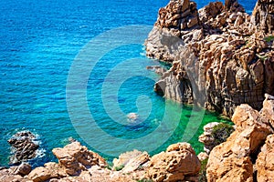 Blue sea and rocks in Costa Paradiso shore on a sunny day