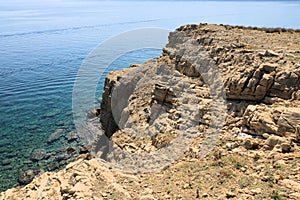 Blue sea and sandstone rocks in Lopar on the island Rab in Croatia