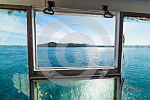 Blue sea in Sardinia seen through a ferry boat window