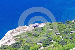 Blue sea shore with wooden canopies for relaxation view from above