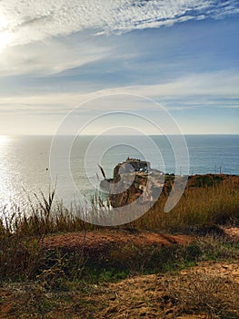The blue sea with the sky with clouds