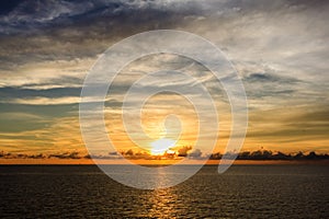 Blue sea and sky with sun red light reflected in the open sea