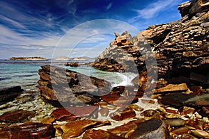 Blue sea and sky, waves breaking off shore, beautiful rock coast, California, USA